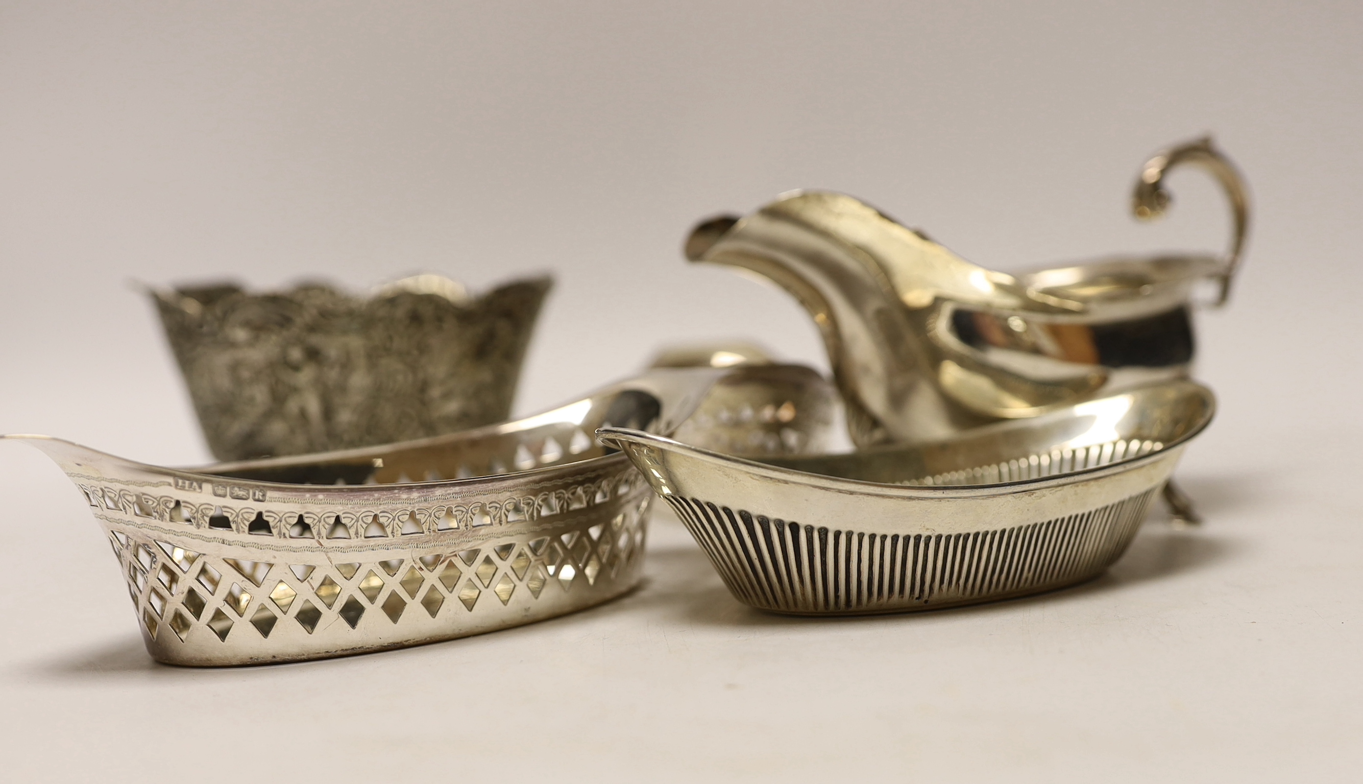 A George V silver sauce boat, three silver bonbon dishes, a small silver bowl and a Hanau white metal bowl.